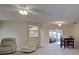 Open-concept living room with neutral carpet and adjacent dining area, perfect for entertaining at 3141 Heron Shores Dr, Venice, FL 34293