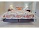 Inviting bedroom with a comfy seashell-themed quilt, side tables with lamps and neutral walls creating a serene space at 3141 Heron Shores Dr, Venice, FL 34293
