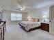 Spacious main bedroom featuring a ceiling fan, window, and comfortable furnishings at 3141 Heron Shores Dr, Venice, FL 34293
