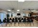 Spacious meeting room with tables, chairs, and a well-equipped kitchen in view at 3141 Heron Shores Dr, Venice, FL 34293