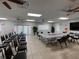 Large meeting room with tables, chairs, and a ceiling fan at 3141 Heron Shores Dr, Venice, FL 34293