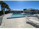 Community pool with lounge chairs and palm trees against a clear blue sky at 3141 Heron Shores Dr, Venice, FL 34293