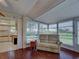 Sunroom with wood-look flooring and sliding doors leading to outdoor patio at 3141 Heron Shores Dr, Venice, FL 34293