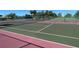 Well-maintained community tennis courts with lush greenery offer a fantastic amenity for active residents at 3141 Heron Shores Dr, Venice, FL 34293