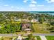 Aerial view of the home, manicured yard and waterfront views in the distance at 329 Myrtle Ave, Nokomis, FL 34275