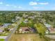 Aerial view of a beautiful home with solar panels and an enclosed pool in a neighborhood with mature trees and blue skies at 329 Myrtle Ave, Nokomis, FL 34275
