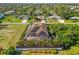 An aerial view of a beautifully landscaped home with a private pool and a lush, green neighborhood near the water at 329 Myrtle Ave, Nokomis, FL 34275