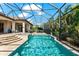 View of the expansive pool, spa, and covered patio area, perfect for relaxing and entertaining outdoors at 329 Myrtle Ave, Nokomis, FL 34275