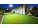 Backyard putting green with manicured lawn and privacy landscaping with view of the house at 329 Myrtle Ave, Nokomis, FL 34275