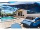 Outdoor bliss awaits with the covered patio, screened pool, spa and chaise lounges for relaxing poolside at 329 Myrtle Ave, Nokomis, FL 34275