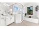 Bright bathroom featuring dual sinks, a glass walk-in shower, and a separate bathtub under a window at 329 Myrtle Ave, Nokomis, FL 34275