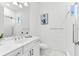 Bright bathroom with white marble and silver fixtures, featuring glass shower and vanity with dual sinks at 329 Myrtle Ave, Nokomis, FL 34275
