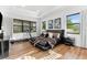 Bedroom featuring a large bed, wood floors, and exercise equipment by the window at 329 Myrtle Ave, Nokomis, FL 34275