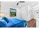Cozy bedroom with a queen bed, natural light from the window, and hardwood floors at 329 Myrtle Ave, Nokomis, FL 34275