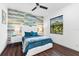 Bright bedroom with a queen bed, stylish accent wall, dark hardwood floors, and modern decor at 329 Myrtle Ave, Nokomis, FL 34275