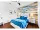 Bright bedroom featuring a queen bed, cool accent wall, and crisp white trim at 329 Myrtle Ave, Nokomis, FL 34275