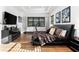 Bedroom with dark furniture, wood floors, and natural light from large windows at 329 Myrtle Ave, Nokomis, FL 34275