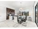 Dining room with glass table, modern chandelier, and wood accent wall with coffee bar at 329 Myrtle Ave, Nokomis, FL 34275