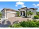 A charming single-story home with a manicured lawn, lush landscaping, and a wide driveway leading to the garage at 329 Myrtle Ave, Nokomis, FL 34275