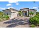 Elegant single-story home featuring a tile roof, paver driveway, attached two-car garage, and well-maintained landscaping at 329 Myrtle Ave, Nokomis, FL 34275