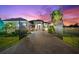 Gated, single-story home with meticulously maintained landscaping and brick paved driveway at 329 Myrtle Ave, Nokomis, FL 34275