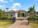 Charming single-story home with a paved driveway, well-manicured landscaping, and a secure gated entrance at 329 Myrtle Ave, Nokomis, FL 34275