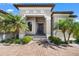 Charming front entrance with lush landscaping, brick pavers, and an elegant front door at 329 Myrtle Ave, Nokomis, FL 34275