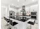 Contemporary kitchen features a large island with seating, stainless steel appliances, and white cabinetry at 329 Myrtle Ave, Nokomis, FL 34275