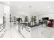 Bright open-concept kitchen with white cabinets, a large island, and stainless steel appliances at 329 Myrtle Ave, Nokomis, FL 34275