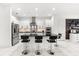 Bright kitchen featuring stainless steel appliances, breakfast bar, and abundant cabinet space at 329 Myrtle Ave, Nokomis, FL 34275