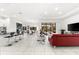 Expansive living room featuring modern decor, marble floors, and sliding glass doors for seamless indoor-outdoor living at 329 Myrtle Ave, Nokomis, FL 34275