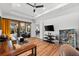 Open concept living room with hardwood floors, large sliding glass doors, and modern furniture at 329 Myrtle Ave, Nokomis, FL 34275