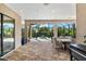 Elegant outdoor patio featuring a dining area and views of the private pool and lush tropical landscaping at 329 Myrtle Ave, Nokomis, FL 34275