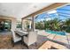 A relaxing outdoor dining area with tranquil views of the pool and backyard at 329 Myrtle Ave, Nokomis, FL 34275