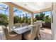 Stylish outdoor dining space overlooking the pool and beautifully landscaped backyard at 329 Myrtle Ave, Nokomis, FL 34275