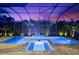 A luxurious backyard pool and spa area enhanced by nighttime lighting at 329 Myrtle Ave, Nokomis, FL 34275