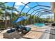 Unwind outdoors with a screened-in pool, spa, and lounge chairs for ultimate relaxation and enjoyment at 329 Myrtle Ave, Nokomis, FL 34275
