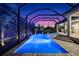Enjoy nighttime swims in the glowing pool and attached spa, all privately screened in for year-round enjoyment at 329 Myrtle Ave, Nokomis, FL 34275