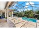 Stunning pool with spa, surrounded by lush tropical landscaping and an enclosed screen at 329 Myrtle Ave, Nokomis, FL 34275
