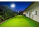 A spacious putting green in the backyard of this home at dusk at 329 Myrtle Ave, Nokomis, FL 34275