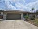 Charming single-story home with a well-maintained lawn and attached two-car garage at 3311 Papaya Rd, Venice, FL 34293