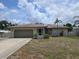 Charming single-story home featuring an attached garage, well-maintained lawn, and inviting front entrance at 3311 Papaya Rd, Venice, FL 34293