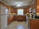 Bright kitchen with light wood cabinetry, granite countertops and updated appliances at 3311 Papaya Rd, Venice, FL 34293