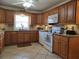 Open concept kitchen features light cabinetry, granite countertops, tile flooring and modern appliances at 3311 Papaya Rd, Venice, FL 34293