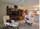 Comfortable living area with entertainment center, plush seating, and a view of the bright kitchen at 3311 Papaya Rd, Venice, FL 34293