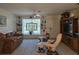 Charming living room offers cozy seating, custom shelving, and a bright, inviting atmosphere at 3311 Papaya Rd, Venice, FL 34293