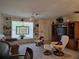 Cozy living room featuring comfortable seating, built-in shelving, decorative stained glass, and a ceiling fan at 3311 Papaya Rd, Venice, FL 34293