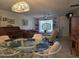 Bright living room features a large window, comfortable seating, and an antique rolltop desk at 3311 Papaya Rd, Venice, FL 34293