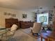 Relaxing living room showcases a comfortable sofa, classic rolltop desk, and built-in shelving at 3311 Papaya Rd, Venice, FL 34293