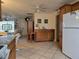 Open floorplan kitchen leading to living space, featuring tile floors, ample cabinet storage, and natural light at 3311 Papaya Rd, Venice, FL 34293